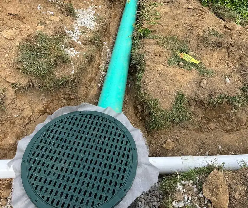 Green and white drainage pipes French Drain Installation Rochester, NY